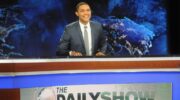 Trevor Noah sits at his desk on The Daily Show