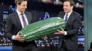 Jimmy Fallon and Seth Meyers hold a giant pickle on Late Night