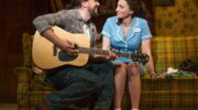 Earl plays Jenna a song on his guitar in Waitress on Broadway