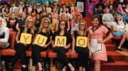 Audience members hold up signs on Rachael Ray