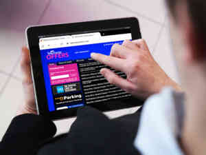 Man Using Telecharge Offers Website on an iPad